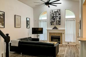 a living room with a couch and a fireplace at Waterfront 2-story home with water views, patio, streaming, washer/dryer, & AC in Jacksonville