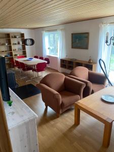 a living room with a couch and a table at Søbugten in Nykøbing Mors