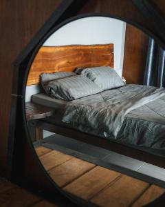 a mirror reflecting a bed in a bedroom at Pondok Beach Shack in Tioman Island
