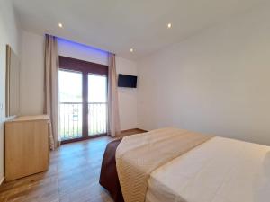 a bedroom with a bed and a large window at Holiday Residence in Masari in Haraki