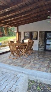 a wooden table and chairs on a patio at Vila Agata in Sinaia
