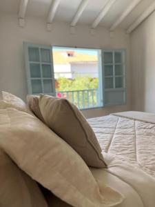 a pillow sitting on top of a bed in a room at Encanto Azul en Villa in Villa de Leyva