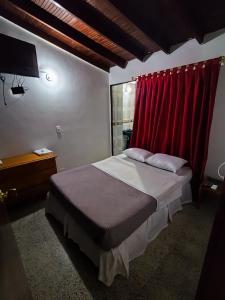 una camera con letto con tenda rossa di Construyendo Sueños JL a Medellín