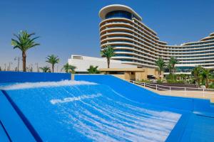 a swimming pool in front of a hotel at Waldorf Astoria Lusail, Doha in Doha