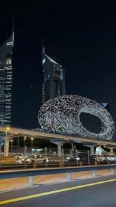 un edificio con un cartel encima por la noche en Dubai Entire Serviced Room Unit Excellence, en Dubái
