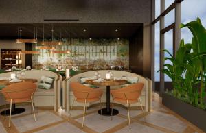 a restaurant with two tables and chairs and plants at Doubletree By Hilton Lagoa Azores in Lagoa