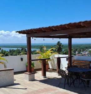 a patio with tables and chairs and a view of the ocean at ALTOS DE VIRGINIA 57 in Sánchez