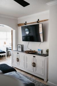 a white cabinet with a tv on a wall at IT'S A SHORE THING - stay, relax, & enjoy! in Clearwater Beach