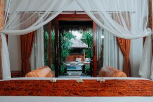 a view of a bedroom with a bed and a mirror at Way Ubud House in Ubud