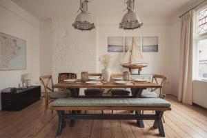 a dining room with a table and a boat on the wall at Fairhaven in Dartmouth