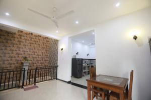 a living room with a table and a brick wall at Surfside Retreat Weligama in Weligama