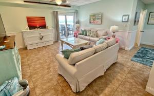 a living room with a couch and a table at Your Beach Therapy Awaits at Sans Souci in Pensacola Beach