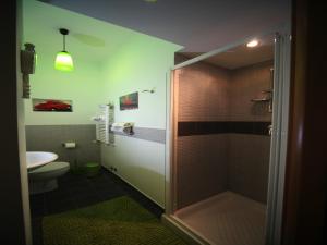 a bathroom with a shower and a toilet and a sink at Napoli Porta Di Mare in Naples