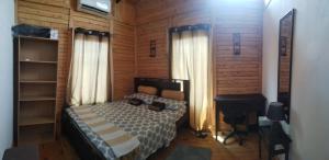 sypialnia z łóżkiem i biurkiem w pokoju w obiekcie Cabaña la Corteza w mieście Tanque