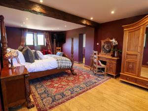 a bedroom with a large bed and a dresser at Farm View Hall in Harrogate