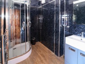 a bathroom with a shower and a sink at Farm View Hall in Harrogate