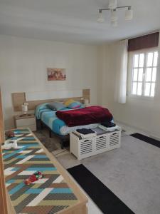 1 dormitorio con cama y alfombra en PRECIOSA CASA DE 4 HABITACIONES EN PLENO CORAZÓN DEL CAMINO DE SANTIAGO!, en Palas de Rei 