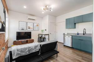 a living room with a couch and a kitchen at Trendy Loft Escape with Pool Table Bring Your Pets in Columbus