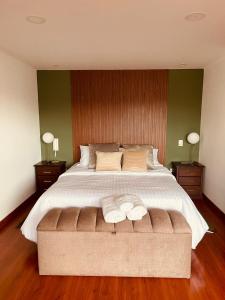 a bedroom with a large bed with two towels on it at Disfruta en Cuenca Semana Santa in Cuenca