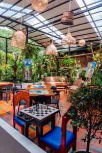 a restaurant with tables and chairs and plants at Spa Hosteria Miramelindo in Baños
