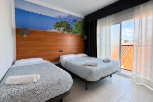 Postel nebo postele na pokoji v ubytování Hotel Maremagnum