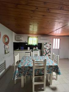 a dining room with a table and a kitchen at Departamentos Avellaneda in Carhué