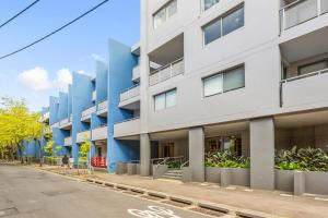 ein Apartmenthaus in einer Stadtstraße in der Unterkunft Spacious 1-Bed with Pool & Gym 5 Minutes from CBD in Sydney