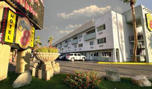 a building with a flower pot on the side of a street at Super 8 by Wyndham Las Vegas North Strip/Fremont St. Area in Las Vegas