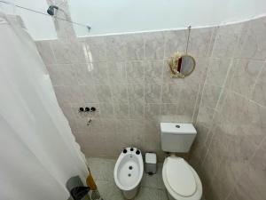 a small bathroom with a toilet and a bidet at La Casa de Agos in La Rioja