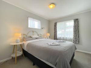 a bedroom with a large bed and a window at Home in central Auckland in Auckland