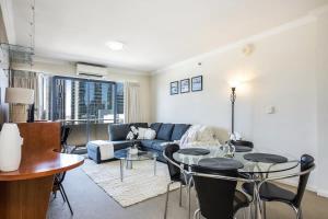 sala de estar con sofá y mesa en Convenient 2-Bed Apartment in the Heart of Perth en Perth