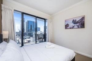 a bedroom with a bed and a large window at Convenient 2-Bed Apartment in the Heart of Perth in Perth