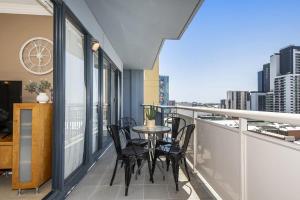 a balcony with chairs and a table on a balcony at Convenient 2-Bed Apartment in the Heart of Perth in Perth