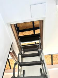 a staircase in a room with a ceiling at LUXURY APARTMENTS CHINITAS 11 in Málaga