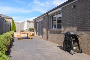 a scooter parked on a sidewalk next to a building at Shoalhaven Escape Cowes in Cowes