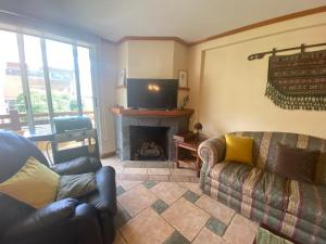 a living room with a couch and a fireplace at Pucon departamento in Pucón