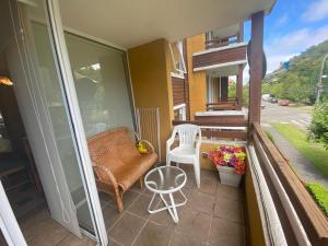 a balcony with a couch and a chair and a table at Pucon departamento in Pucón