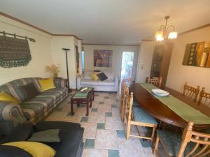 a living room with a couch and a table at Pucon departamento in Pucón
