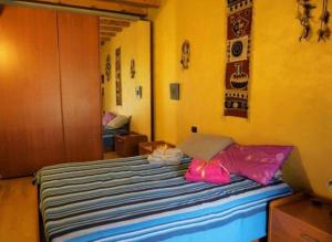 a bedroom with a bed with a pink umbrella at La casa dell'ulivo in Brembate