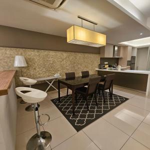 a kitchen and dining room with a table and chairs at Royal Suite in Kuala Lumpur