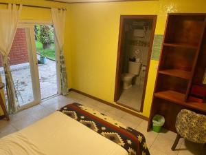 a bedroom with a bed and a bathroom with a toilet at La Casa del Molino Blanco B&B in Baños