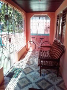 a balcony with a bench and a bike in a room at Port Antonio Residence in Port Antonio