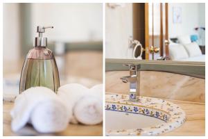 a bathroom sink with a soap bottle and towels at Atico-Terraza Imperial in Toledo
