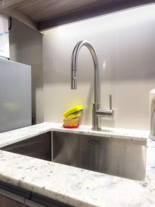 a kitchen sink with a faucet in a kitchen at A2J Luxury 1BR Suite Near Venice Mall BGC Taguig in Manila