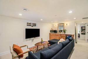 a living room with a blue couch and a tv at 3 Bed Fully Renovated Denver University in Denver