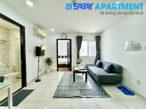 a living room with a couch and a table at Sabay Airport Apartment - The Connect in Ho Chi Minh City