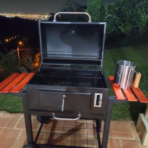 a grill with a laptop computer on top of it at La Villa The View in Pance