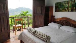 a bedroom with a bed and a balcony with a view at La Villa The View in Cali