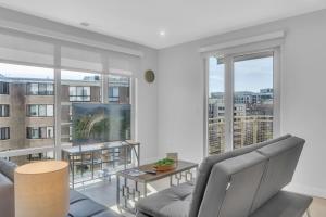 a living room with a couch and a large window at Fully Furnished Apartment in Washington near Logan Circle in Washington