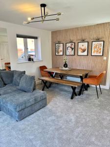 a living room with a table and a couch at Luxury Newly Renovated House in Reading